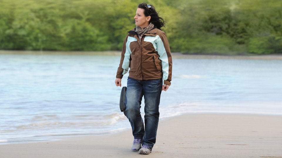 Christin with C-Brace walking on the beach.