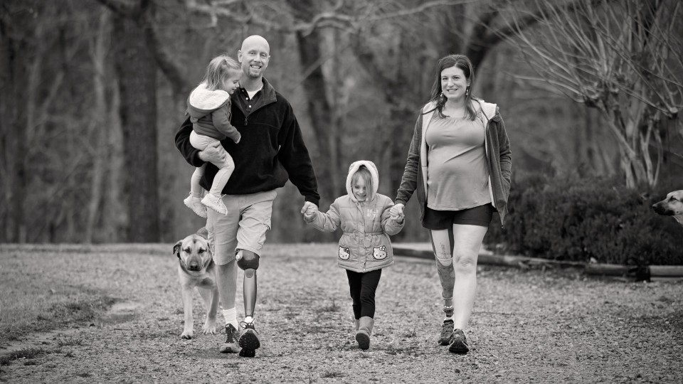 Brad and his wife, Jennifer with their Genium knees spending time with their kids and dogs.