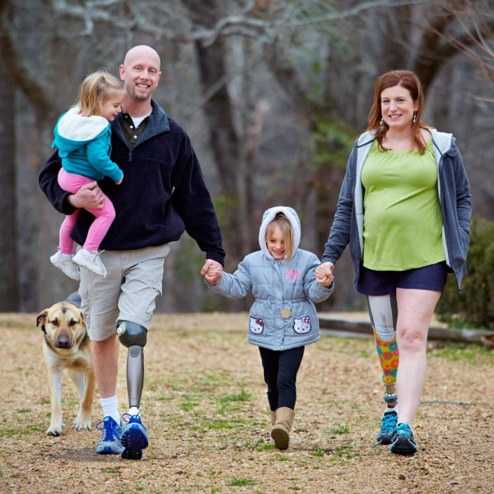 Brad and his wife, Jennifer with their Genium knees spending time with their kids and dogs.