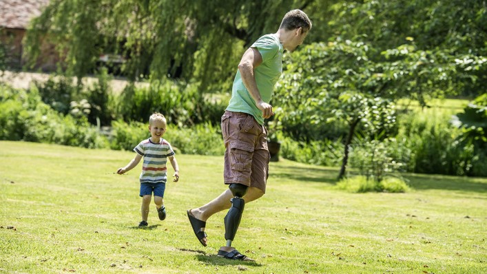 Fun at home in the garden: John plays tag with his young son