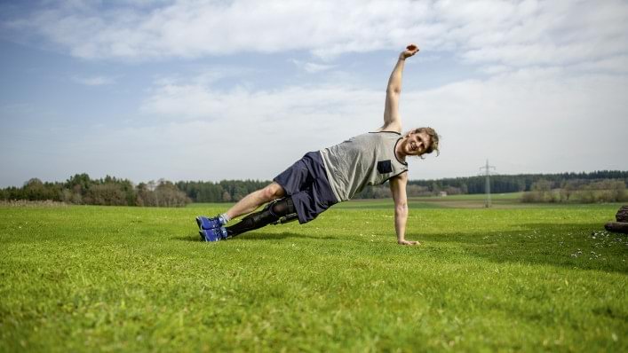 David wears his C-Brace® orthotronic mobility system while doing gymnastics in the garden. 