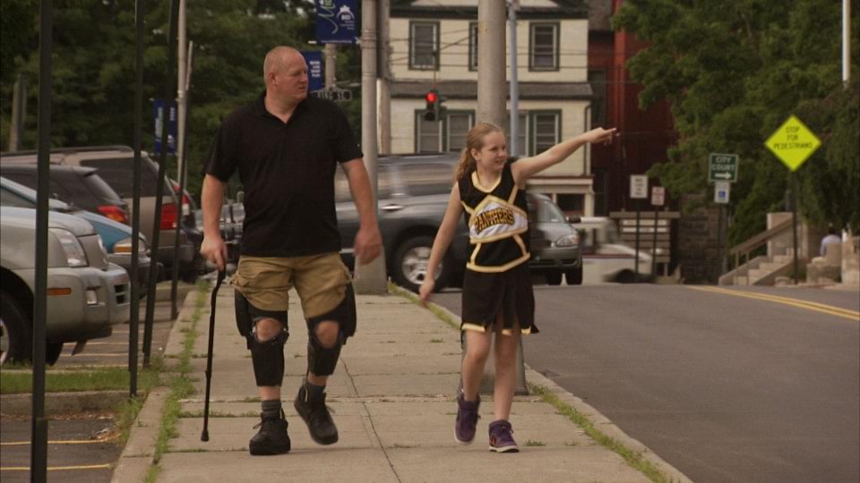 Del walking with daughter using C-Braces.