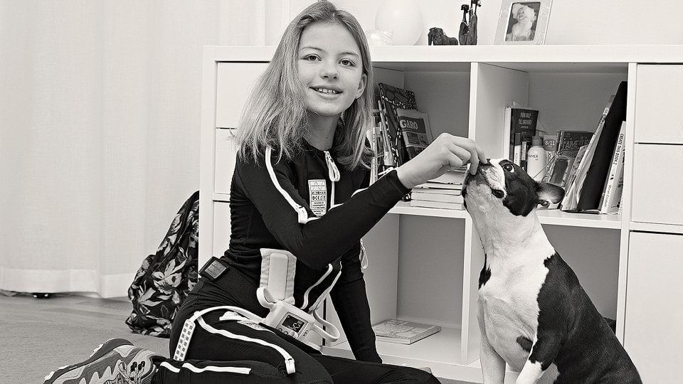 A girl plays with her dog