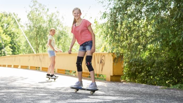 A girl riding skateboard with Patella Pro.