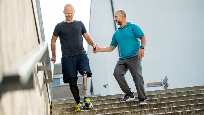 Michael and his physiotherapist on the stairs