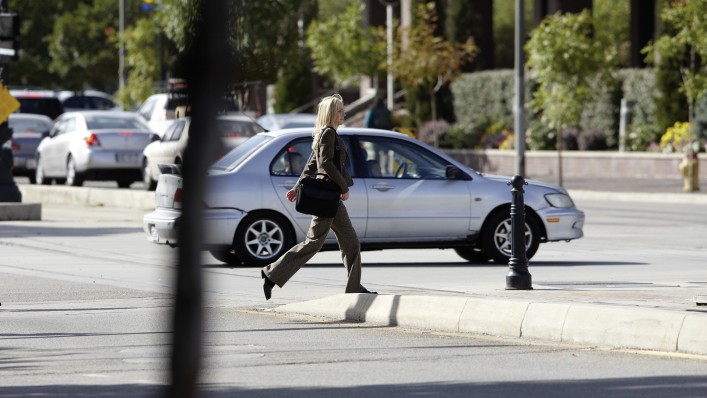 Triton user Brecklyn crosses the street.