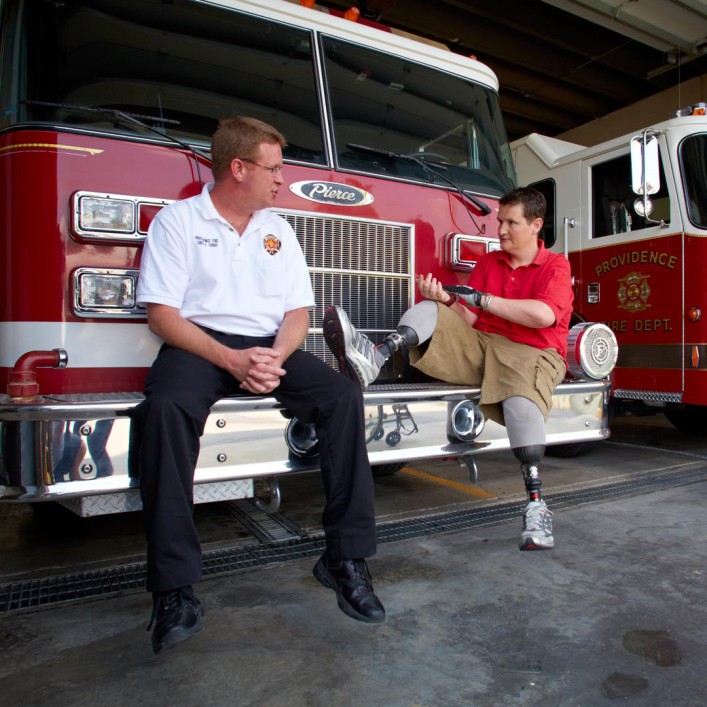 Neil at the fire station with his Harmony prosthetic legs.