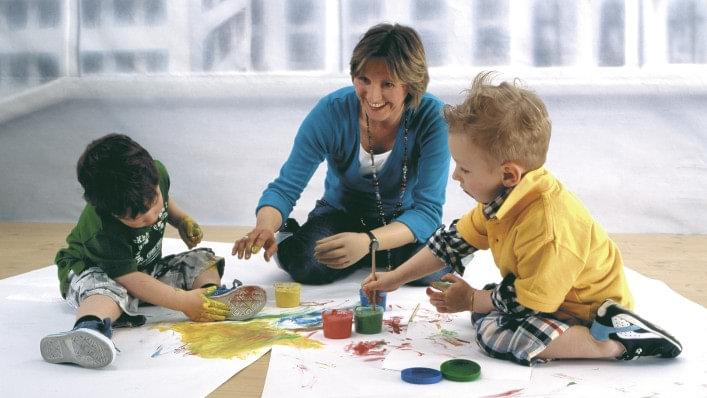 Young mother drawing with her children