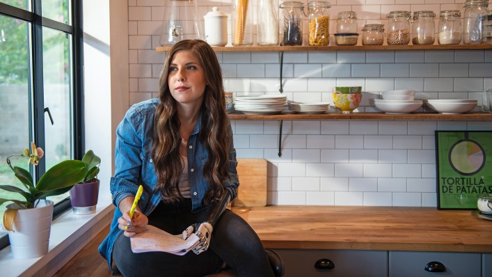 bebionic user Angel sits in the kitchen and reads a script.