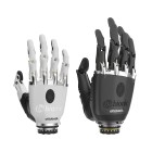 bebionic hand prosthesis in size small and colour white next to a bebionic hand with a prosthetic glove. 