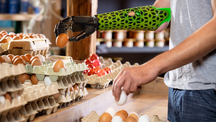 A user with Myo Plus pattern recognition picks up a raw egg with the pinch grip.