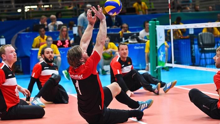 A sitting volleyball player on the attack. 