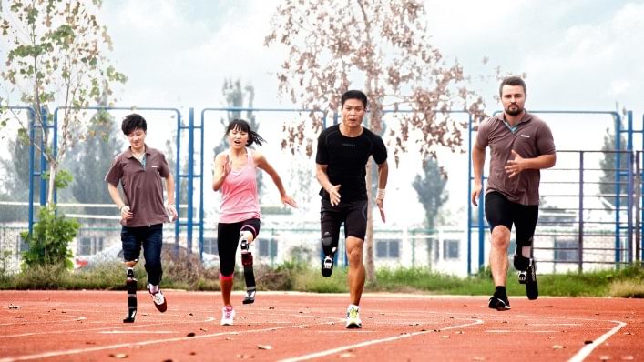 Heinrich Popow läuft mit Teilnehmern der Running Clinics auf Lauffedern. 