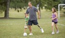 Jonathan wears his C-Leg microprocessor knee to play football with his children.
