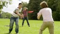Hamed with Genium prosthesis playing frisbee with friends.