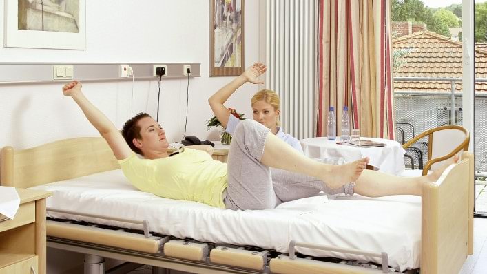 Therapist showing rehabilitation exercise before the amputation.